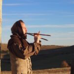 Max playing the Aulos at a megalithic site